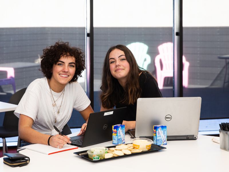 two girls smiling as they study