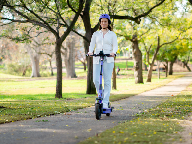 Woman riding scooter in park