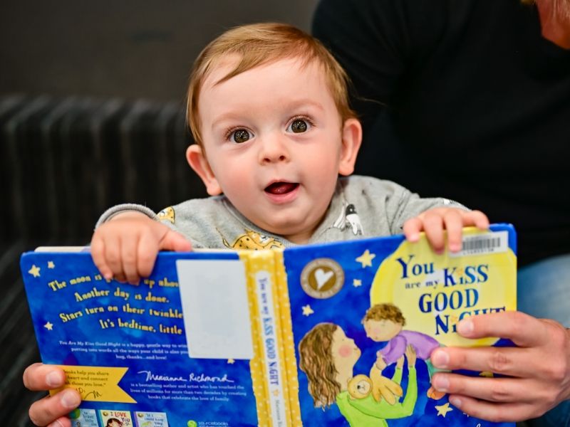 toddler and book