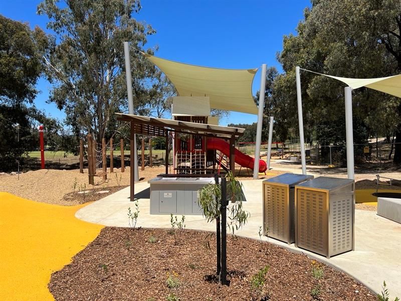 Ernest ground playground with shade from sail and trees