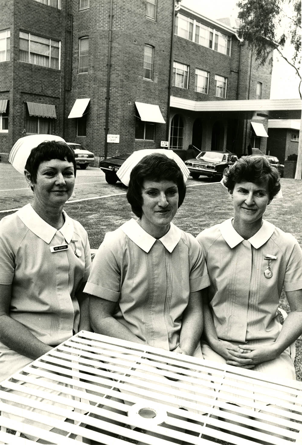 Nurses Baker, Gugger and Frohling sitting in front of Abury Base Hospital, 1975. ARM 12.377.01