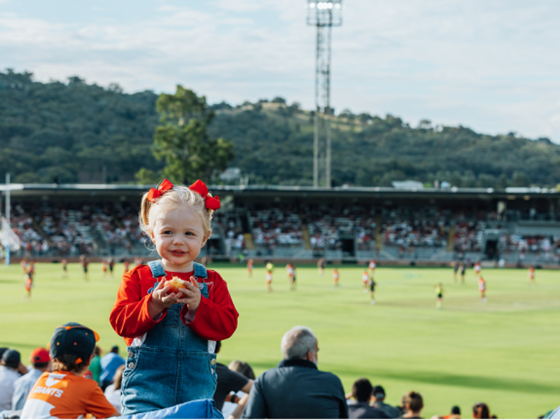 Small child at a football game at the Lavington sports ground