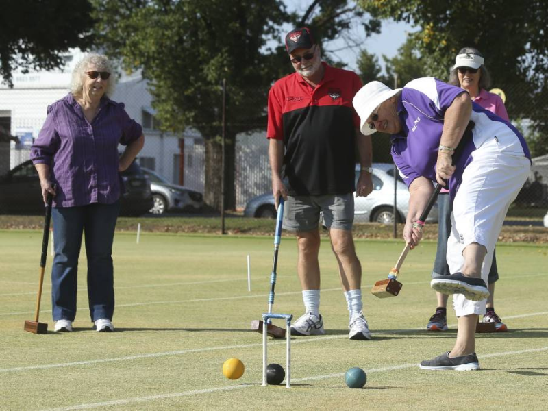 people playing croquet